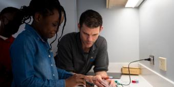 a student and teacher in a workshop at the homewood community engagement center