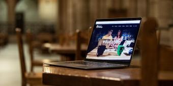 a laptop sitting on a table in the cathedral of learning commons room