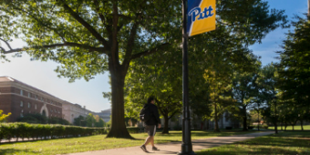 Student on the Varsity Walkway toward the Cathedral of Learning